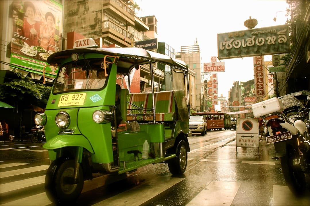 a green bus on the street - Photo by Mil Amirian on Unsplash