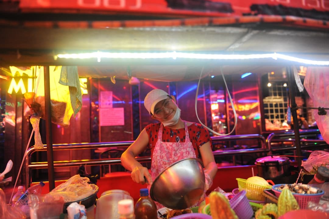smiling woman mixing on gray bowl in foodcourt - Photo by Chris Tweten on Unsplash