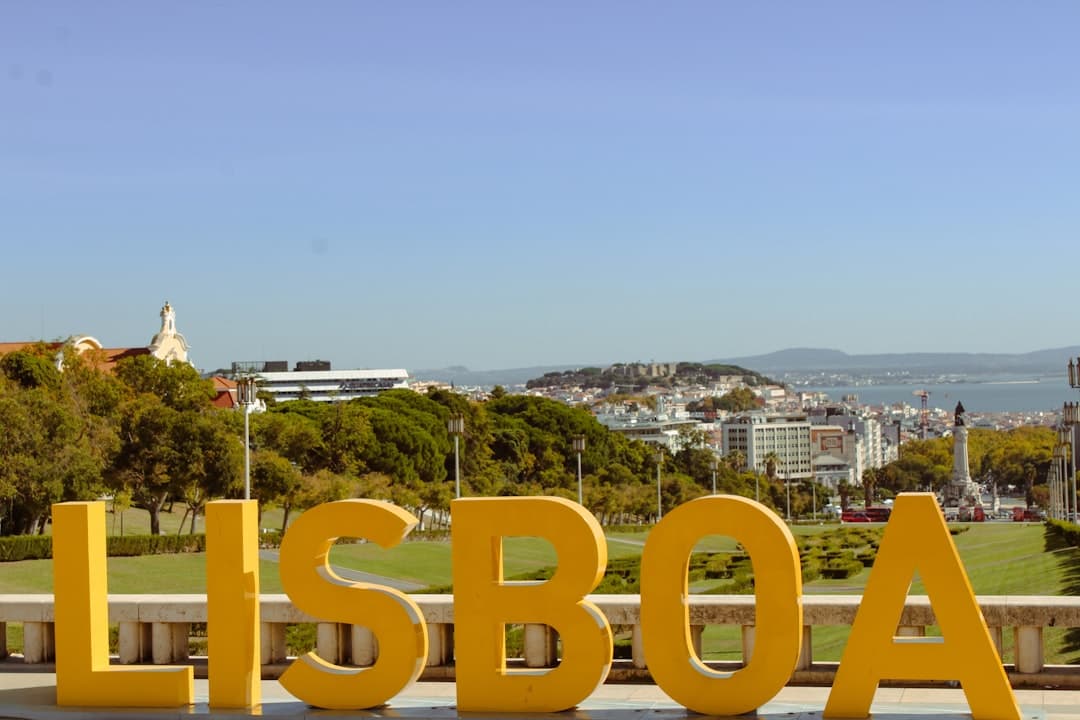 Large yellow lisboa letters with city view - Photo by Felicia Varzari on Unsplash