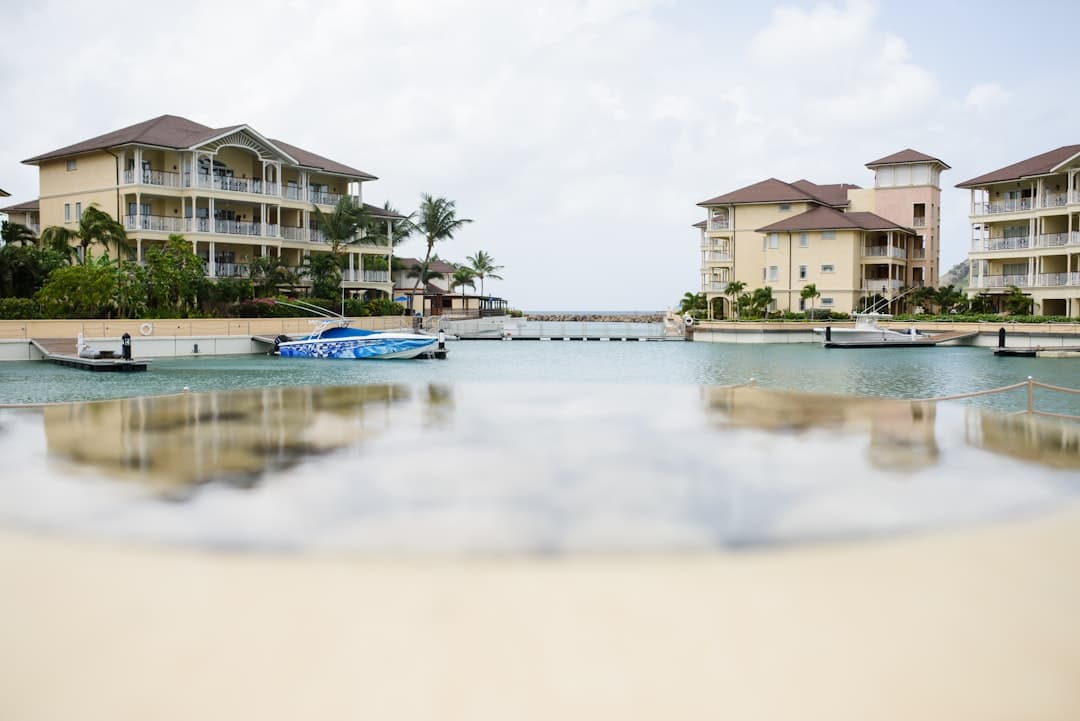 white and brown house near body of water during daytime - Photo by Christina Victoria Craft on Unsplash